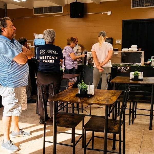 Customers ordering and picking up food at a casual restaurant counter with high-top tables.
